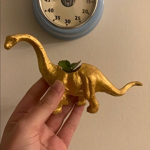 Golden dinosaur planter airplant